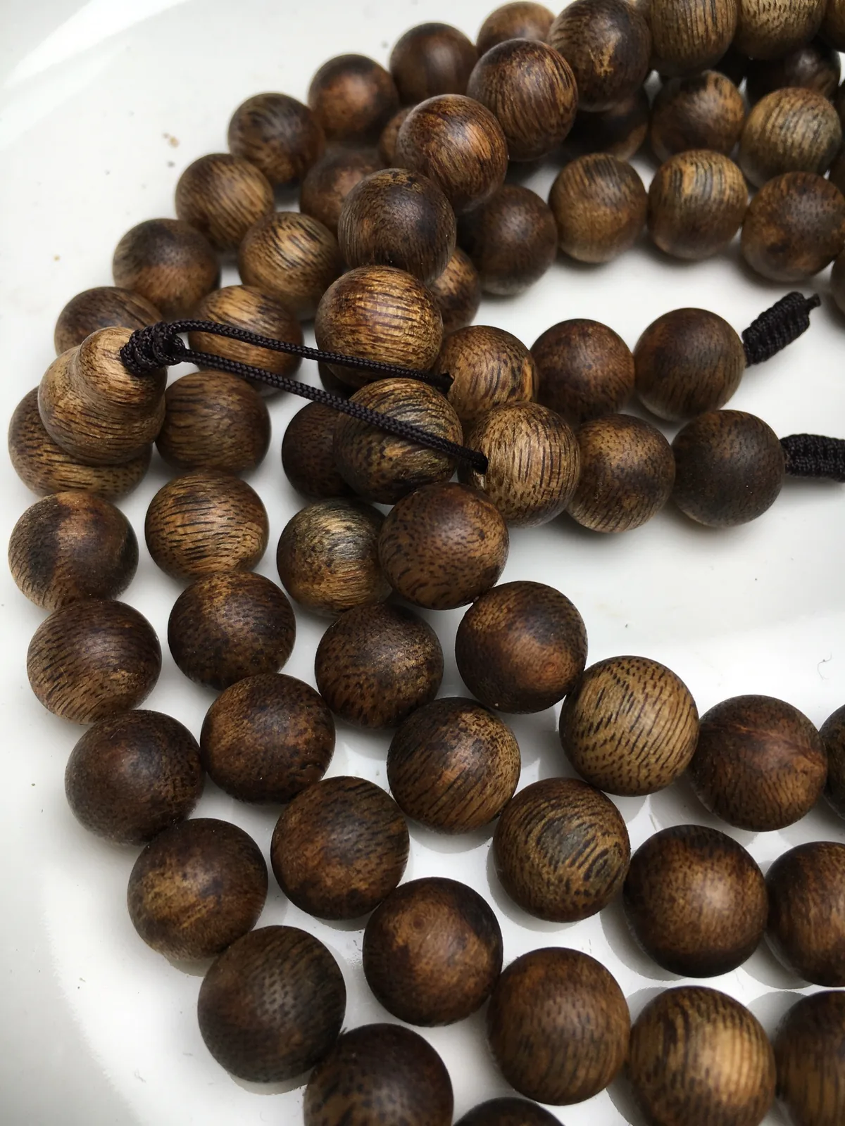 Tasbih meaning in practice: a 99-bead strand of agarwood