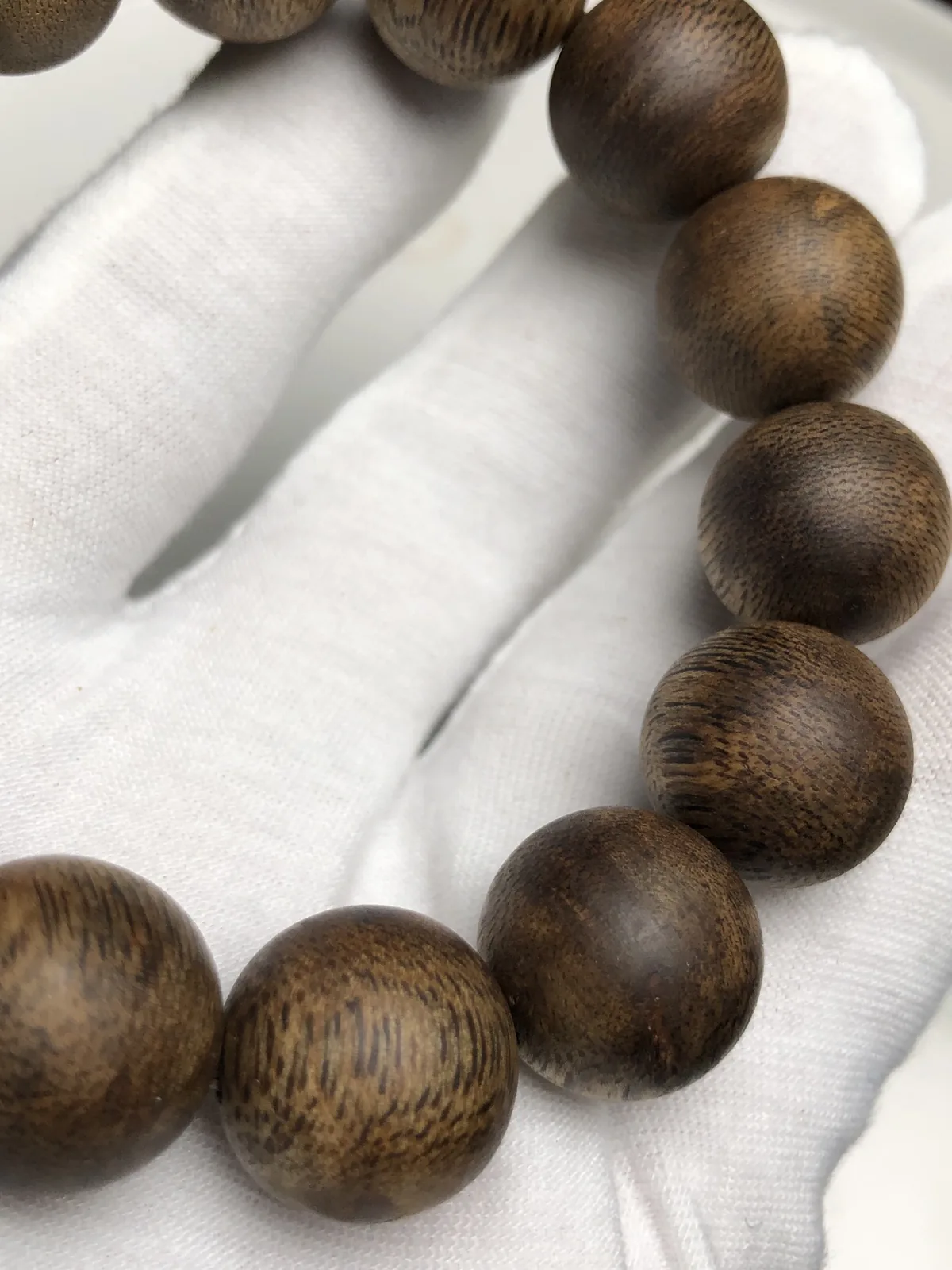 An agarwood strand chosen as the anchor of a bracelet stack