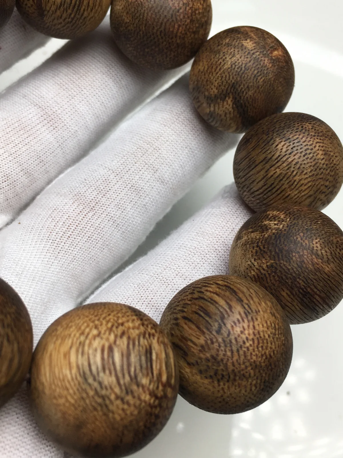 Round bead bracelet on elastic, showing how to tie an elastic bracelet
