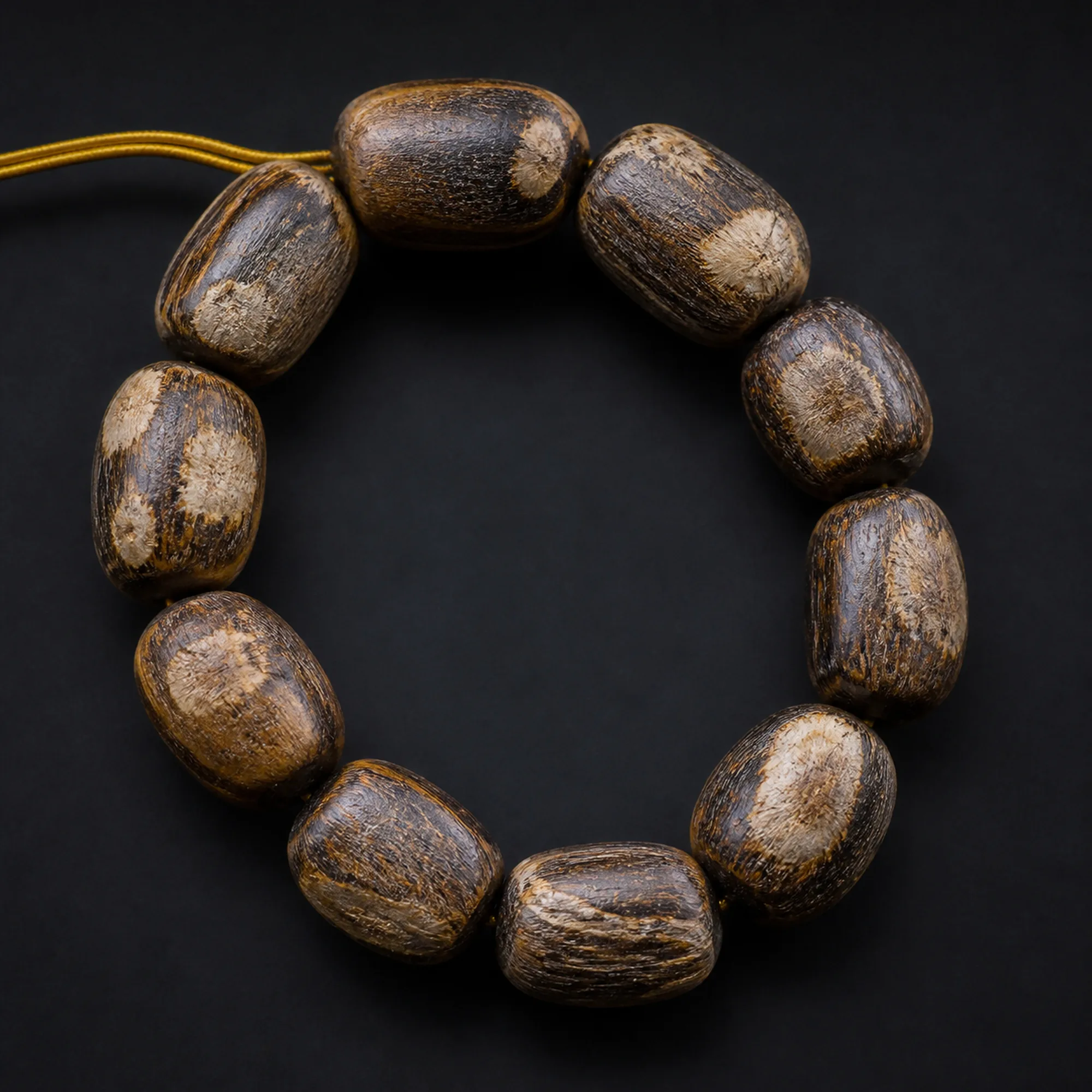 Agarwood bracelet in plantation oud wood on black stone